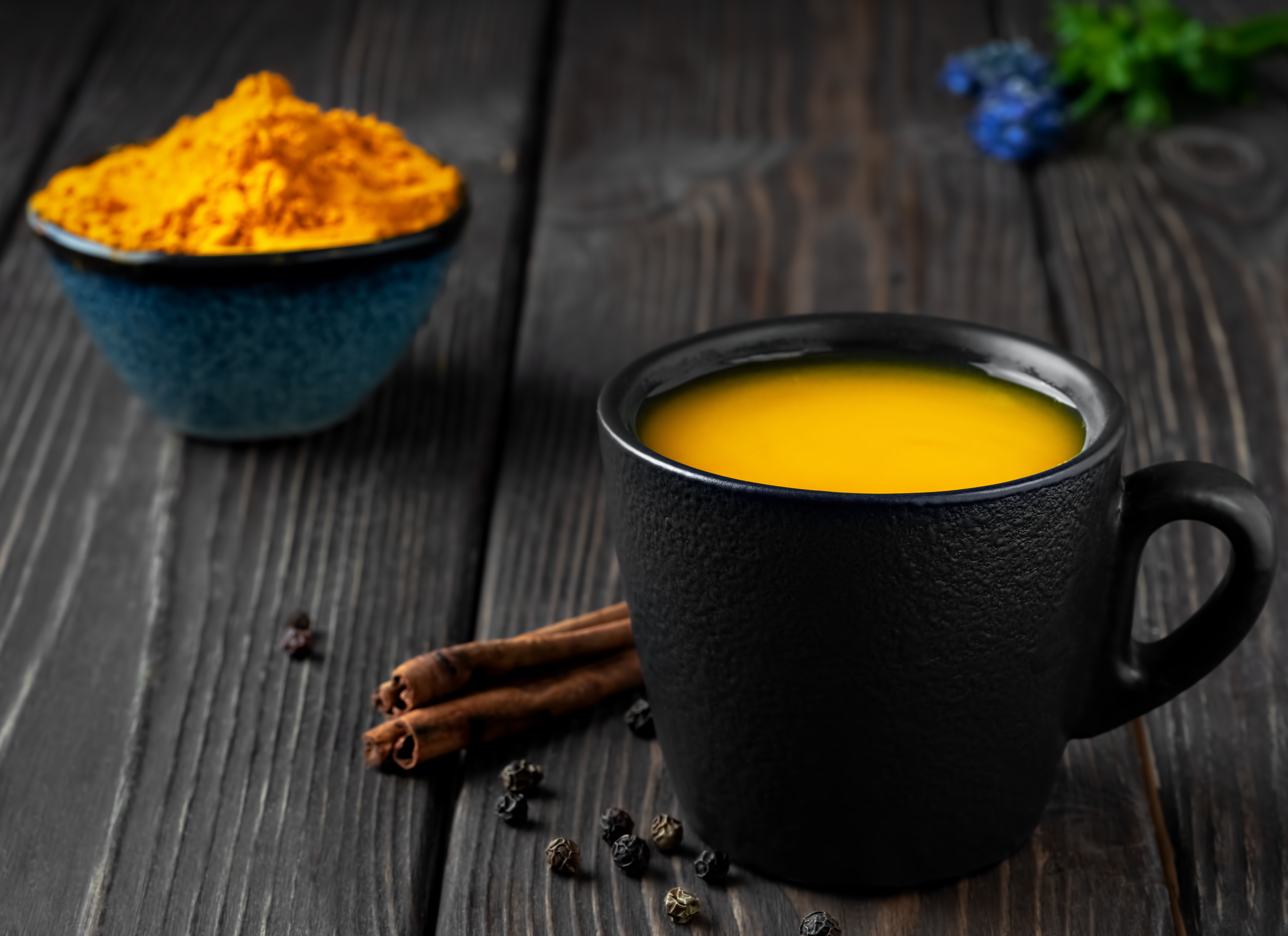 Cup with natural healthy herbal tea made from turmeric, honey and spices. Drink to support immunity against influenza and the common cold. The concept of medicine and a healthy lifestyle. Close up